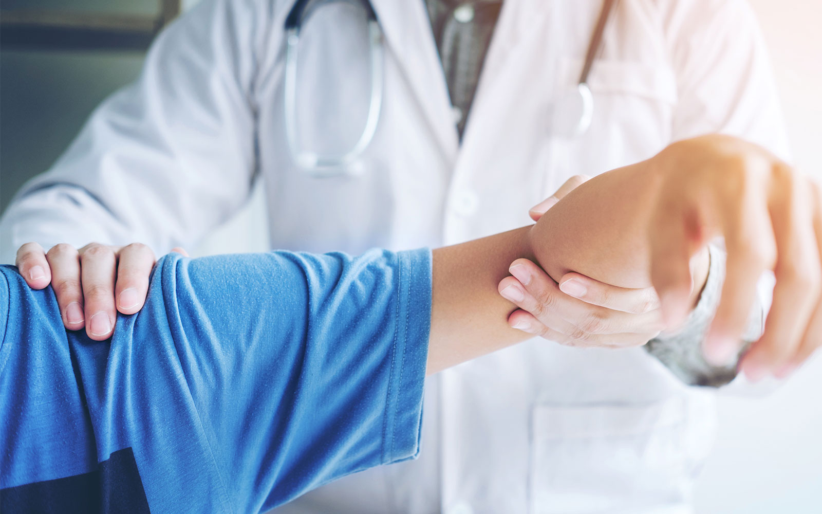 Doctor Surgeon showing patient shoulder range of motion